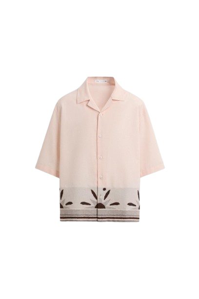 Peach short-sleeve shirt with decorative cutout pattern along the hem.